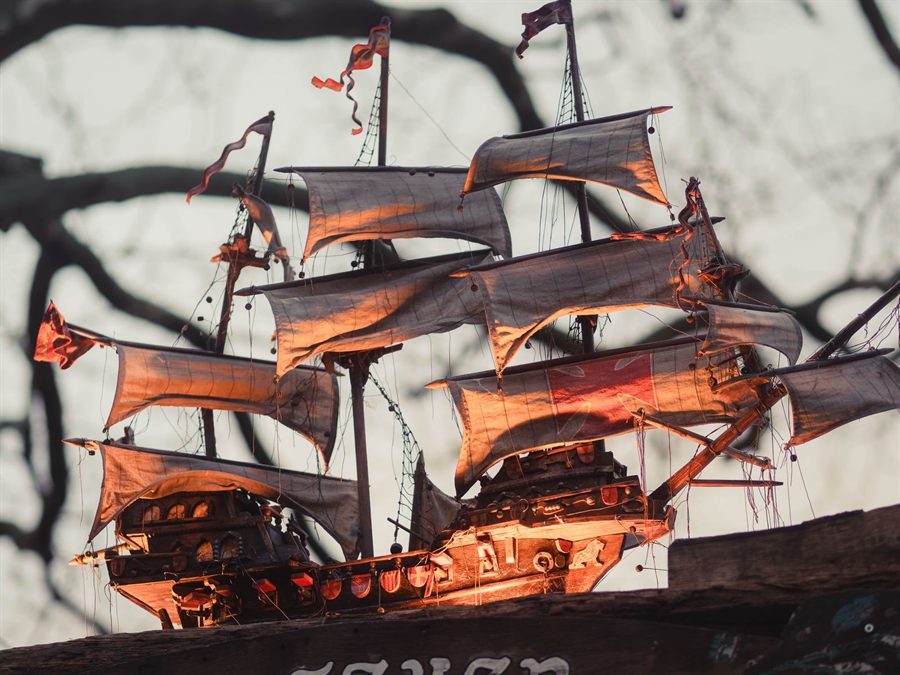 Vintage model ship with billowing sails