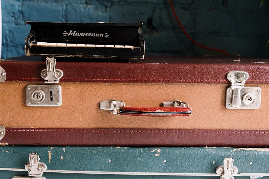 Close-up of old suitcases with metal latches stacked together