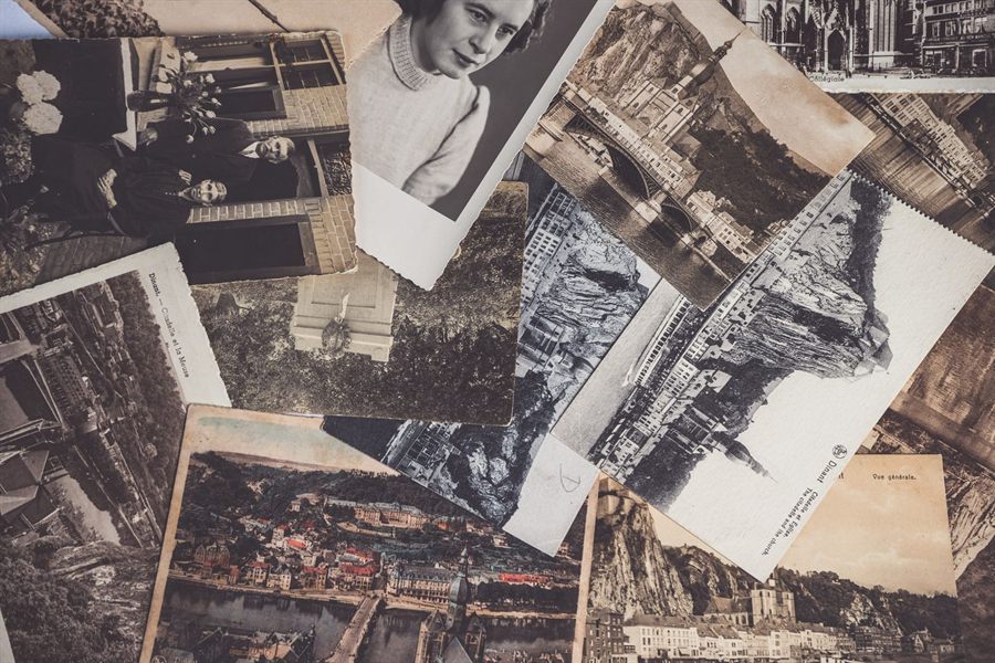 Pile of vintage black-and-white photographs and postcards