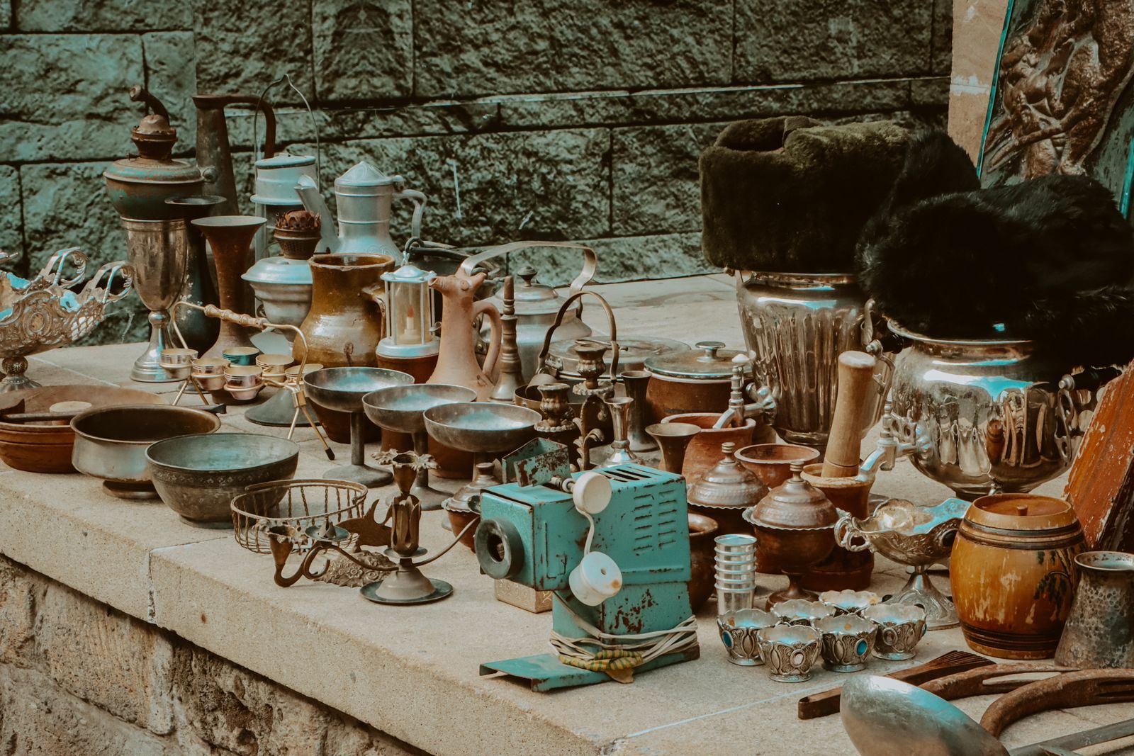 Antique kitchenware and decor on a market stall, where ocean liner memorabilia for sale sometimes turns up